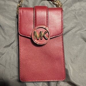 Michael Kors Carmen Small Logo Crossbody Bag in burgundy with gold hardware.